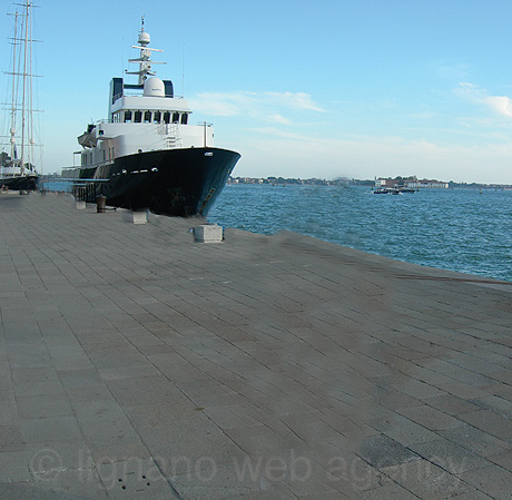 Anchored ship in the port of venice photo